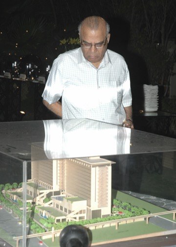 Jagdish Rai Sood reviewing an architectural model